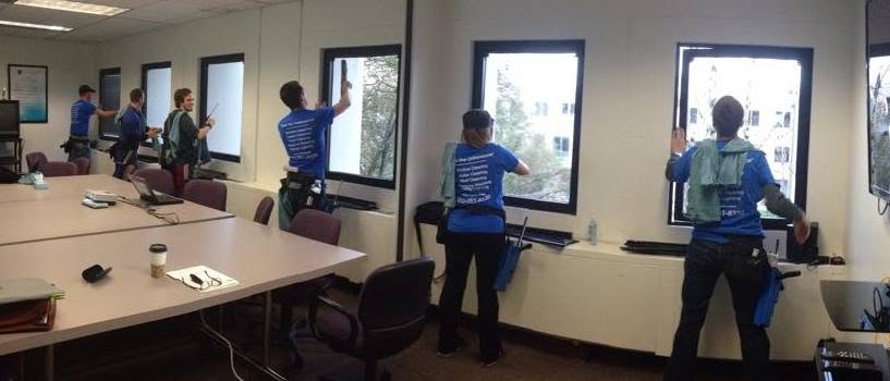 Commercial interior — five-person crew moving a whole office of windows in one pass.